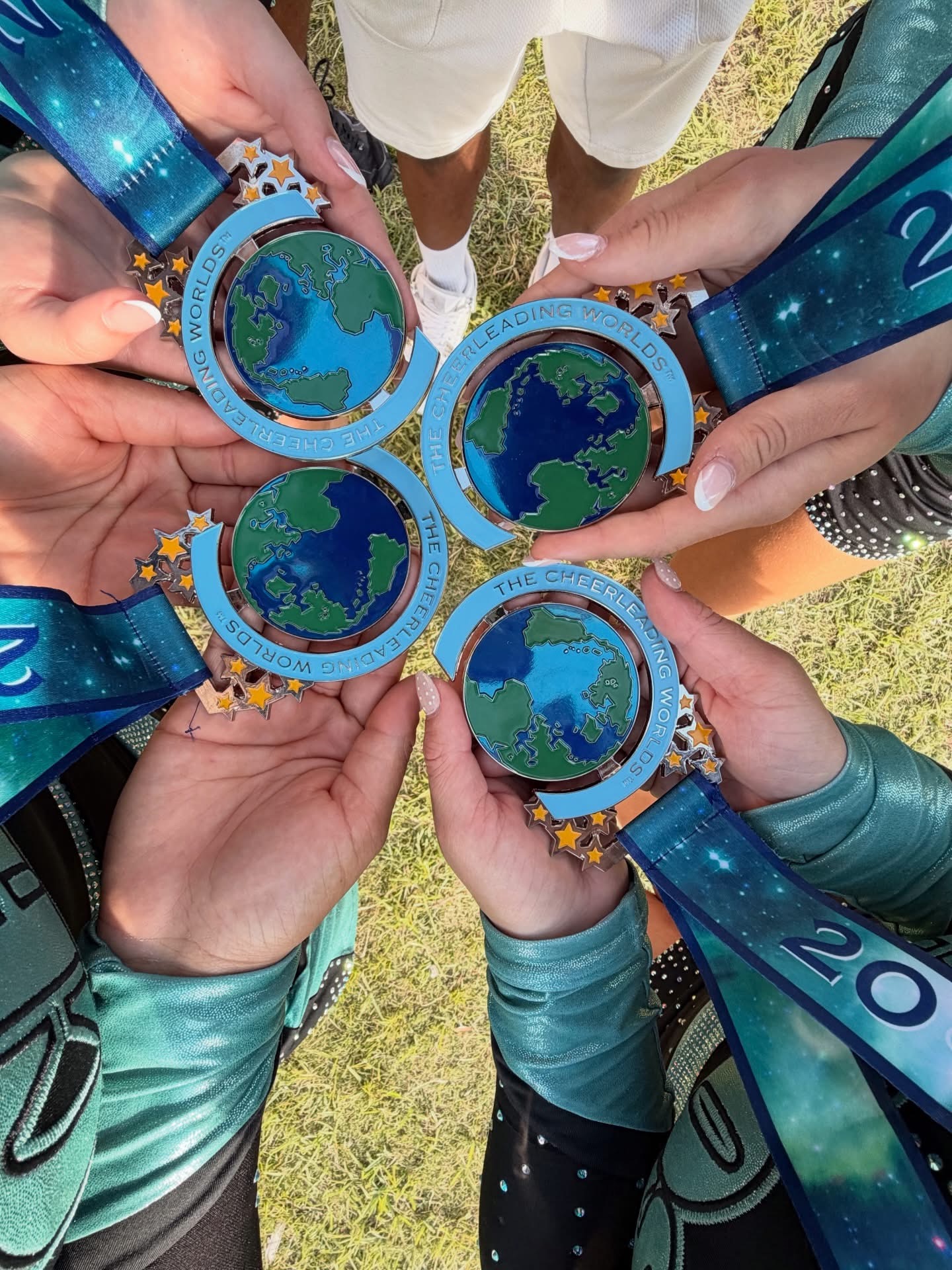 ACA athletes holding their Cheerleading Worlds medals