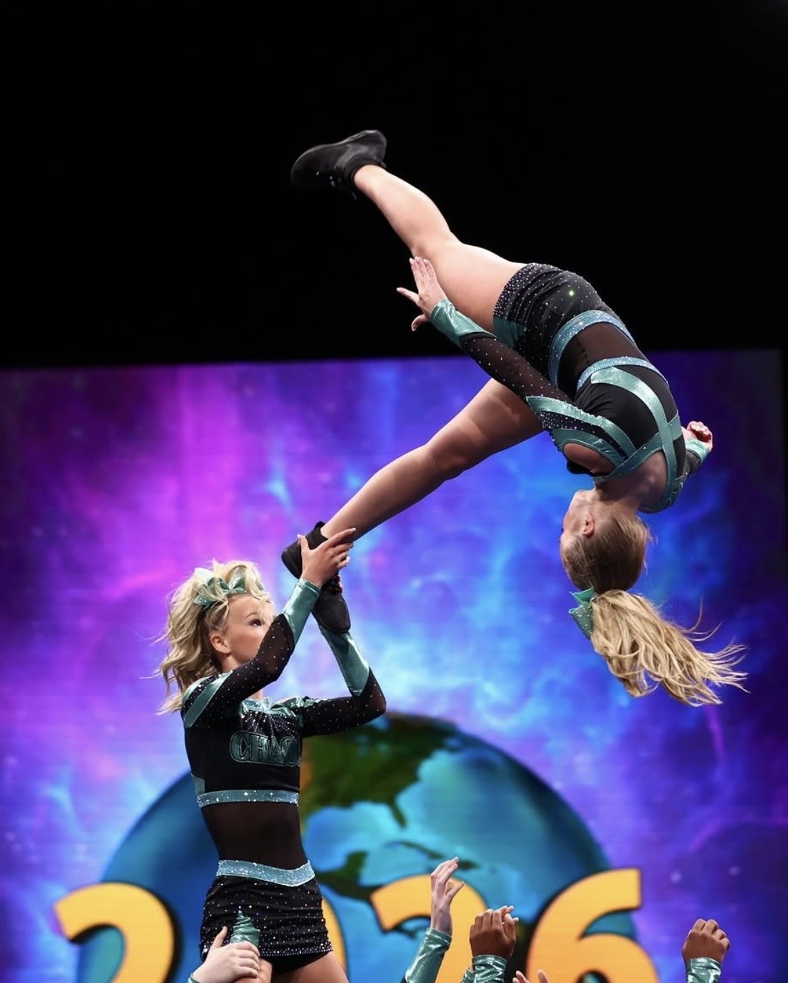 ACA Chaos athletes performing a high flying stunt at Worlds